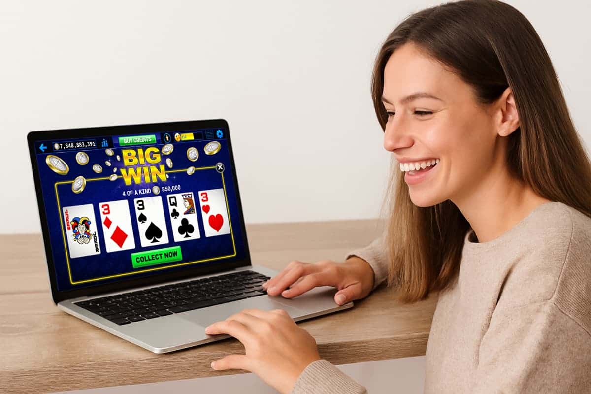 a woman plays video poker on laptop